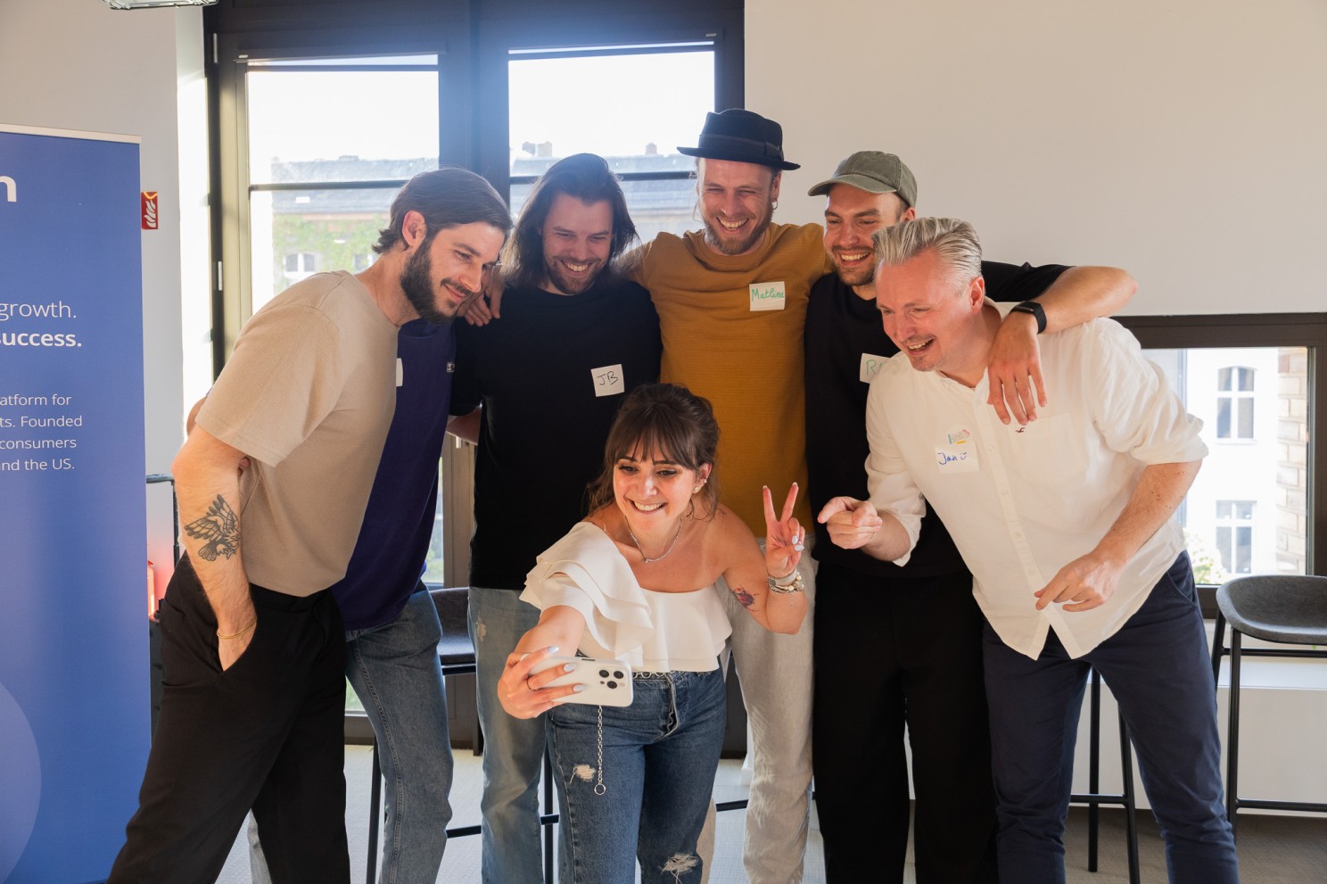 Talent Crunch community members laughing and posing for a group selfie at a workshop event in Berlin.